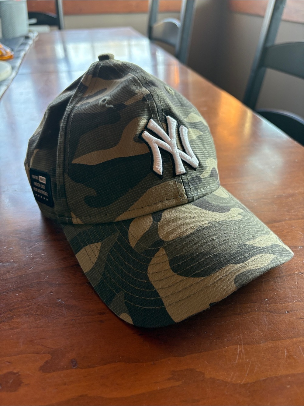 Womans Camouflage Baseball Cap with White NY Yankees logo. Worn once